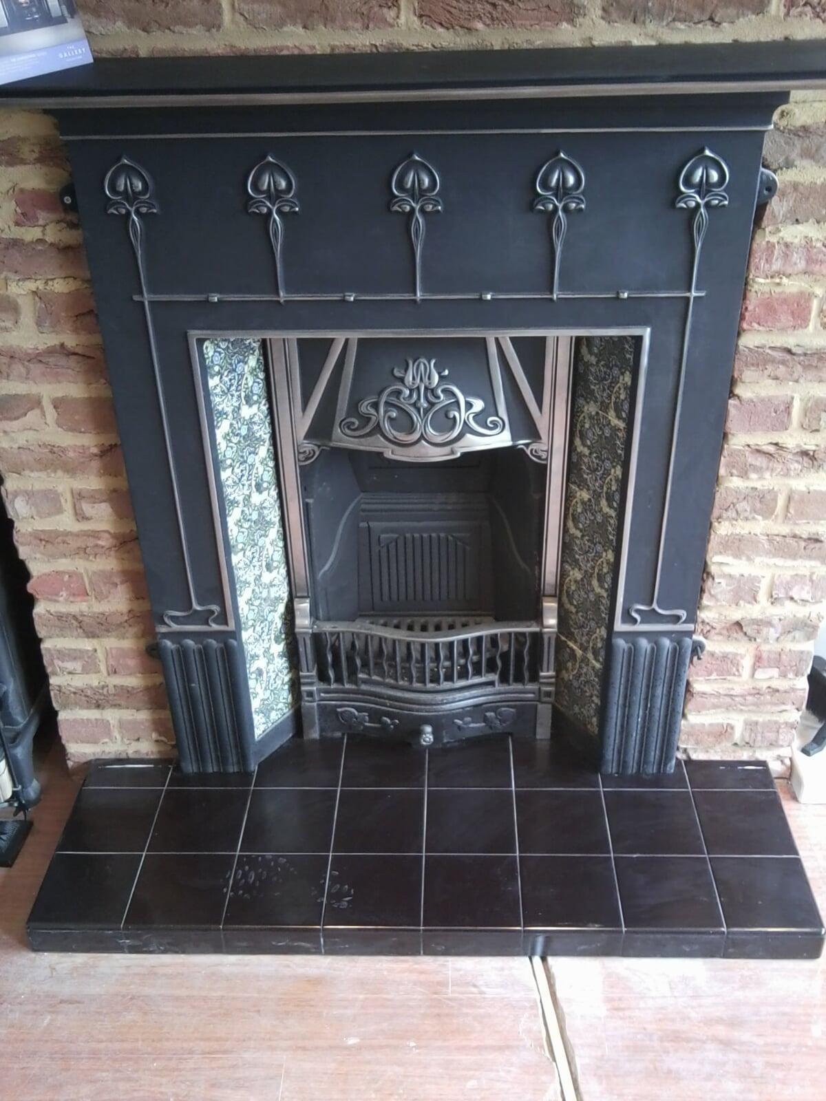 cast fireplace with tiles on tiles hearth